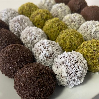 Energy Date Balls, coated with coconut flakes, pistachios,cocoa powder and filled with assorted nuts