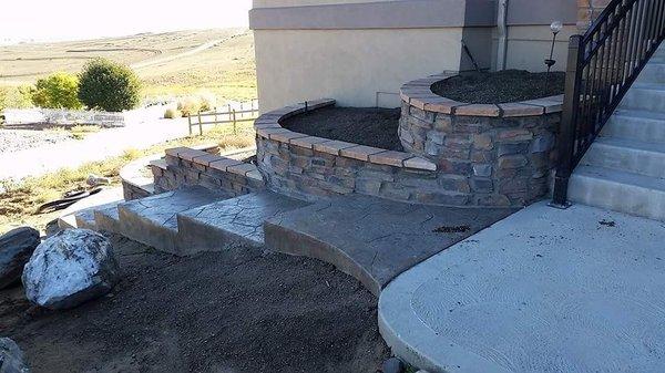 Stone Veneer Planters & Stamped Concrete Sidewalk.