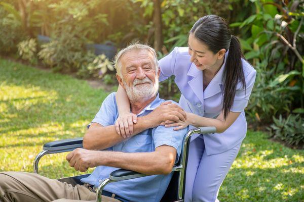 happy-elderly-senior-holding-hands-with-companions-in-caring-personnel