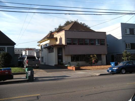 Street view with entrance to parking lot in rear