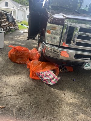 Installers ran over bright orange bags of trash in driveway.