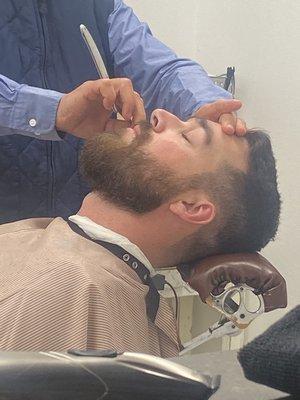 Short to medium beard trim shaped, shaved neck and finished with a natural cheek line up to create fullness.