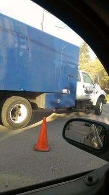 Completely blocking traffic...that cone is actually where the sidewalk is lined up