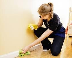 Baseboard cleaning lady working for Mayfer Cleaning