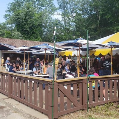 Big bar inside with many tables to eat in. Large outdoor patio with bar.