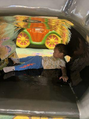 My son under the soft play bridge