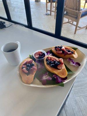 Beautiful breakfast fruit plate with fresh papaya, local Waimea strawberries, and blueberries.