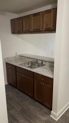 Kitchen cabinet install with counter top and bar