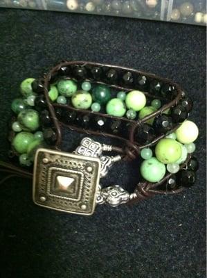 Stunning bracelet made with faceted black onyx, green jade, silver and leather.