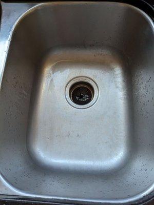 Kitchen sink after she cleaned