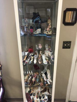 Display case of shoe trinkets in Dr. Branwell's waiting room.