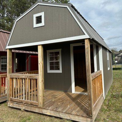 grey lofted barn with a porch