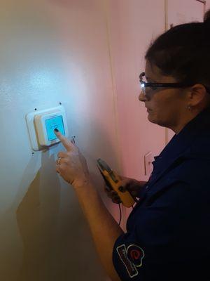 Female technician completing a thermostat install