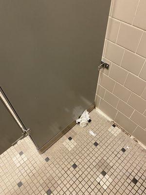 Every stall has some sort of garbage on the floor