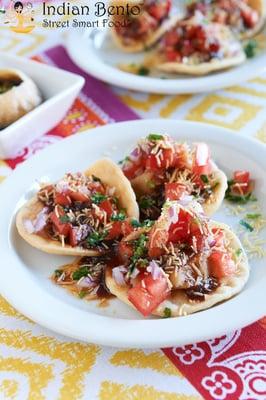 BOMBAY SEV PURI - crispy flat puri with potatoes, garbanzos, onions, tomatoes, cilantro, tamarind, mango marinade.