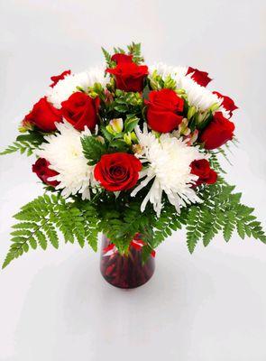 The Dozen plus, 12 long stem roses, greenery complimented with additional fresh seasonal flowers.