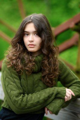 teen girl posing on bridge looking at camera