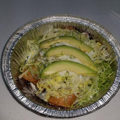 Fried tacos (pork on the inside) with lettuce, avocado & grated cheese on top