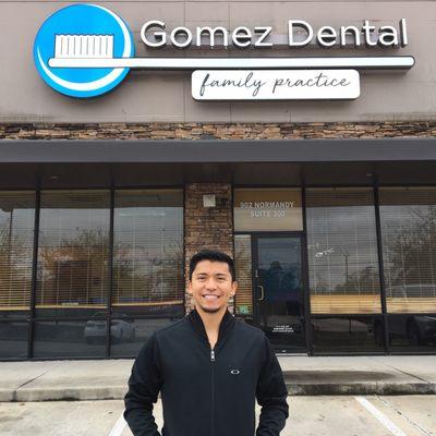 Dr. Gomez in front of the new building sign for his office