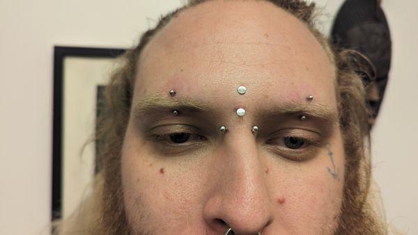 Forehead piercing, bridge piercing and eyebrow piercing