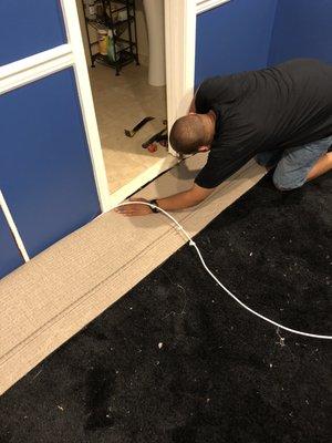 After padding, cutting carpet to size the size of the room .