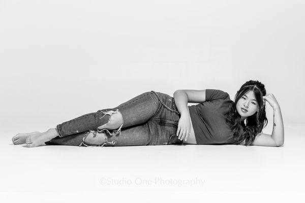 Girl laying down on white background