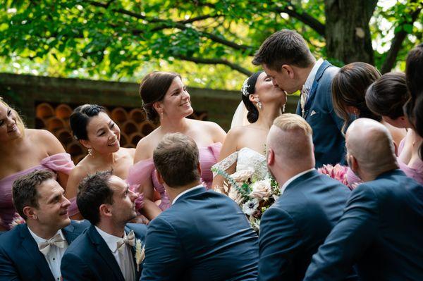 Wedding party surrounding bride and groom