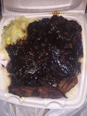 Medium oxtail platter with white rice, cabbage, & sweet plantain. Delicious!