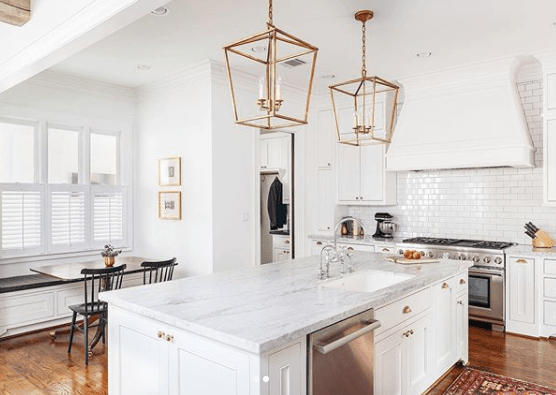 Icy white kitchen with gold accents by Aspire Fine Homes