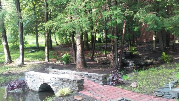 bluestone arched bridge with paving stone walkway