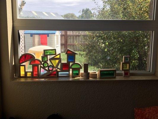 Color blocks highlight the sunshine in the toddler room, looking out onto the toddler play area - children spend time outside daily