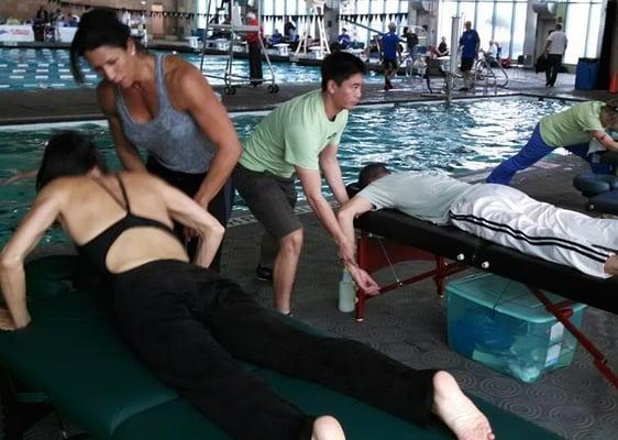 Conducting pre/post Sports Massage on athletes for their swim competitions.