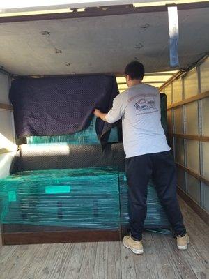 One of our professionals making sure the blankets are securely on the furniture for safe transport.