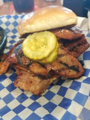 The Manhandler - Texas beef brisket topped with smoked sausage and spicy pickles