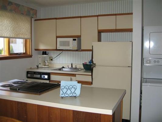 The kitchen has many appliances.  There is also a washer and dryer in each unit.