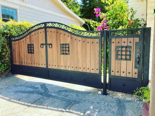 Custom iron frame with redwood t&g inlay, handmade decorative iron pieces that really brought this gate to life