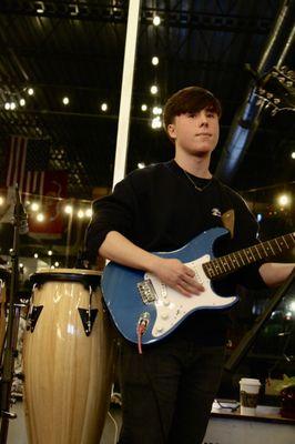 Guitar student ready to play for a live audience