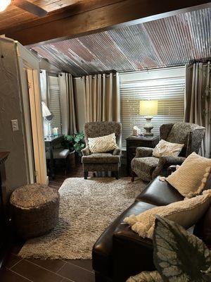 Sitting area of 'king' suite - showing makeup area, leather loveseat, two easy chairs (one is a recliner)