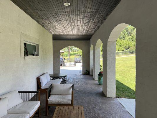 Stamped concrete floor, Wood slot ceiling, stucco walls