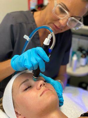 Hydrafacial being applied.