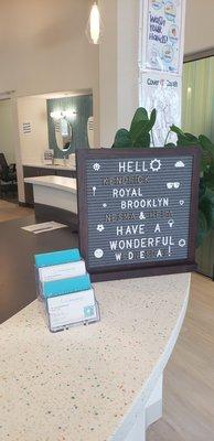 Front desk with sign greeting scheduled patients