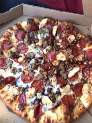 Barbecue pizza sauce, pepperoni, sausage, chicken, bacon, meatballs, and cheese