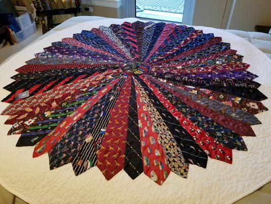 Had to post another. They turned my husband's old ties into what was suppose to be a table cloth but so beautiful using it on my bed.