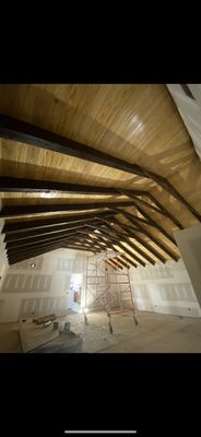 Sheetrock installation , stained beams , & clear coated wood ceiling . Painted Sheetrock after