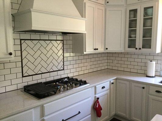 Soft White Painted Kitchen Cabinetry with custom tile back splash.