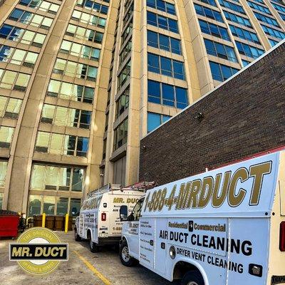 Mr. Duct trucks at a commercial air duct cleaning job site in Chicago.