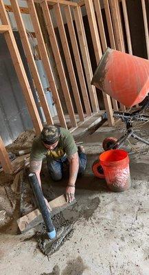 Concrete finishing after plumbing was cut in.