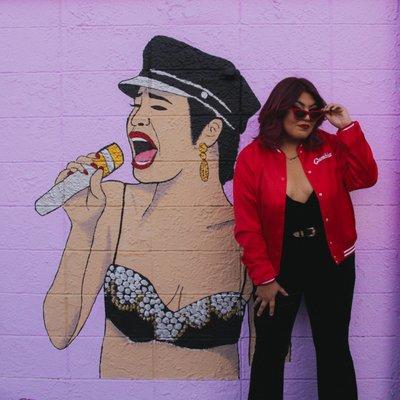 Baila esta Cumbia Jacket infront of our Selena mural