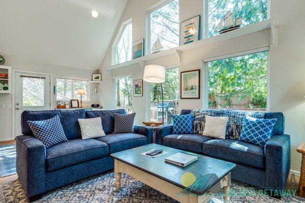 Living and Dining room with large windows at Pelican Perch.