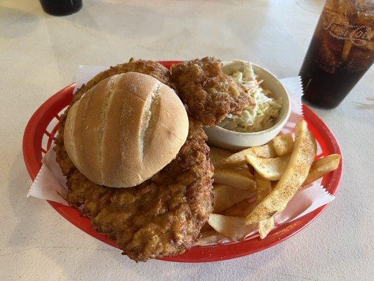 Pork tenderloin sandwich with steak fries and coleslaw